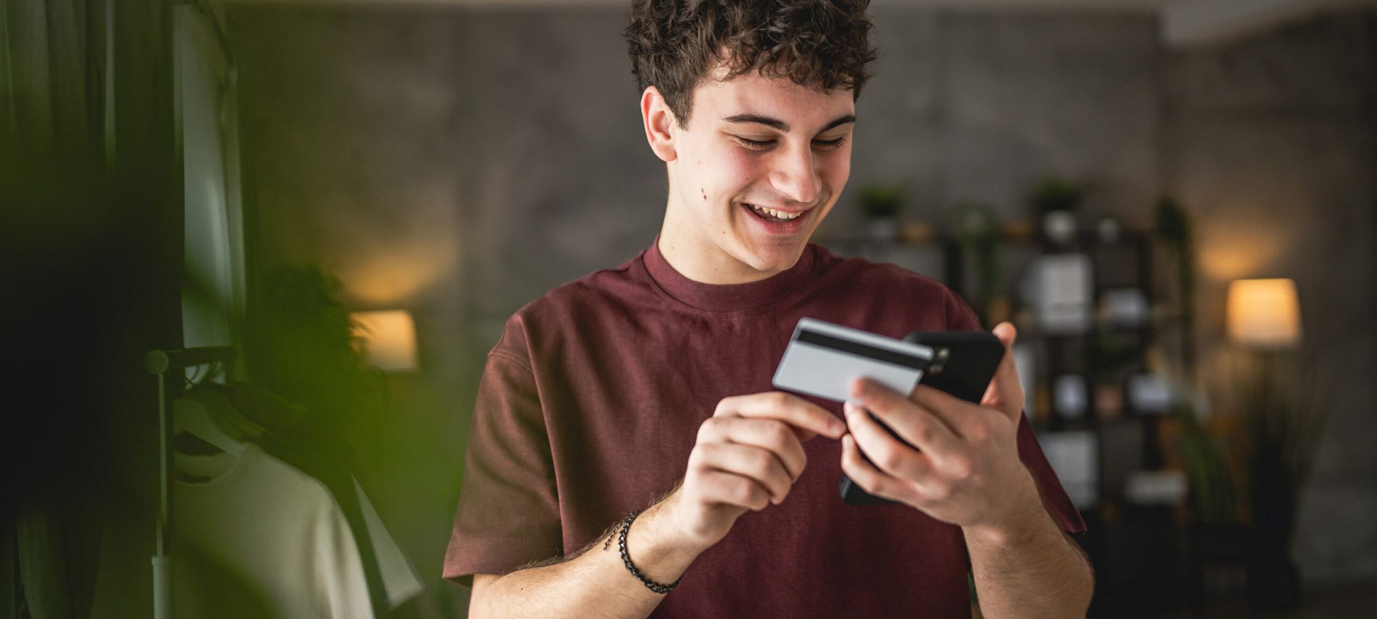 Chico joven mirando el móvil sonriente